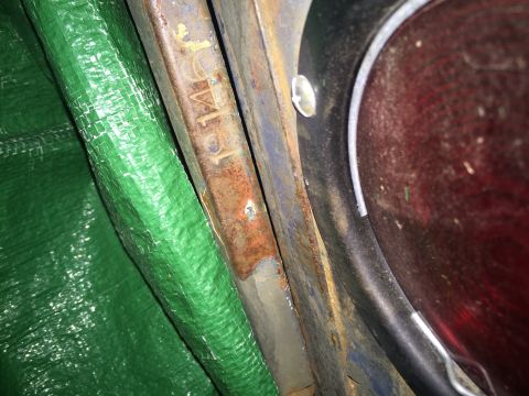 1946 Jeep Willys - A close-up view reveals stamped text on a vehicle's frame, showing 'W1'.
