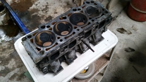 1985 Ford Escort - A used engine cylinder head is shown, indicating internal engine work or repair.