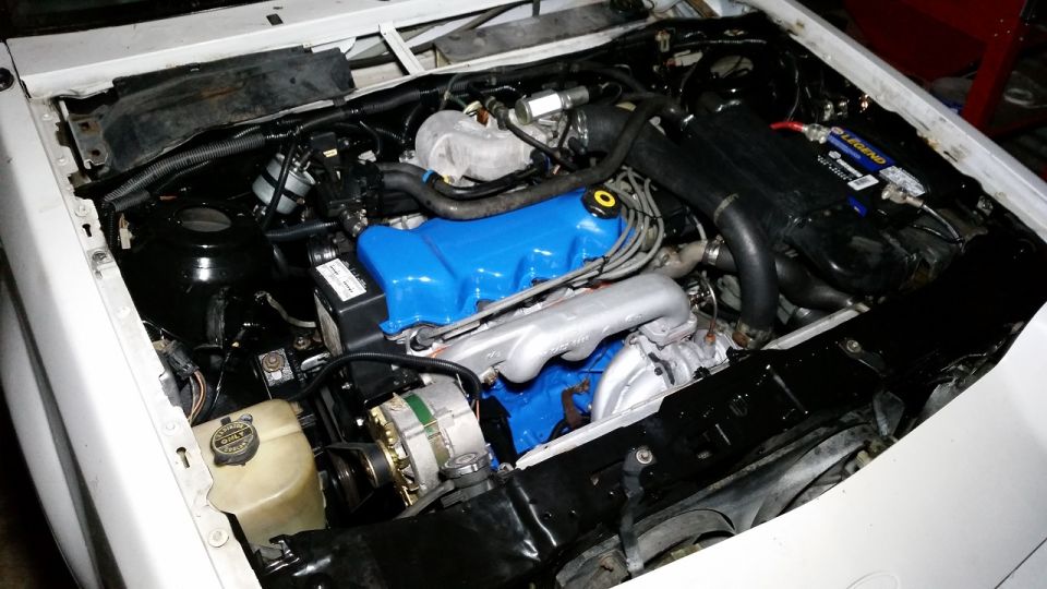 Engine bay with blue valve covers and silver intake manifold