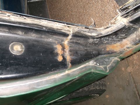 1979 Ford Bronco - This photo shows significant rust and damage on the door frame of a green vehicle, indicating potential structural issues.
