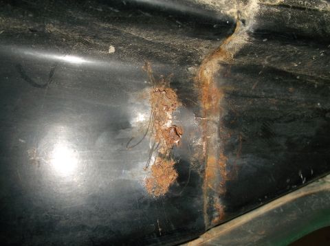 1979 Ford Bronco - Rust damage is visible on the underside of a vehicle, with no clear year identification.