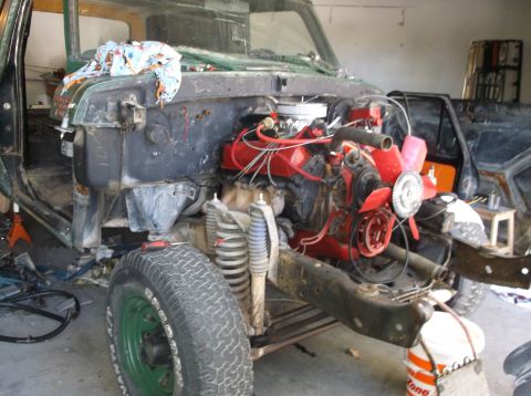 1979 Ford Bronco - This vehicle is undergoing engine work, with the engine compartment partially disassembled.