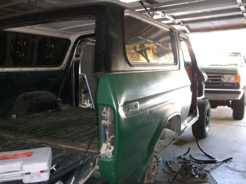 1979 Ford Bronco - This 1979 Ford Bronco is undergoing work in a garage, with a second vehicle visible in the background.