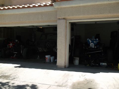 1979 Ford Bronco - Two vehicles are visible in garages, both seem to be undergoing repairs or restoration.