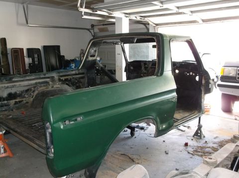 1979 Ford Bronco - 1979 Ford Bronco body undergoing restoration in a garage setting.