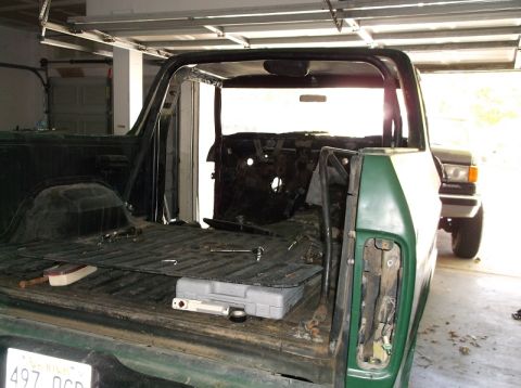 1979 Ford Bronco - This 1978 Ford Bronco is undergoing interior work, with its rear cargo bed exposed and a second vehicle parked behind it.