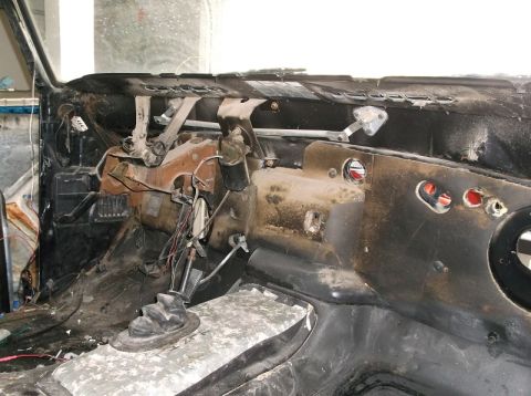 1979 Ford Bronco - The interior of a 1979 Ford Bronco shows a disassembled dashboard with visible wiring and a floor shifter.