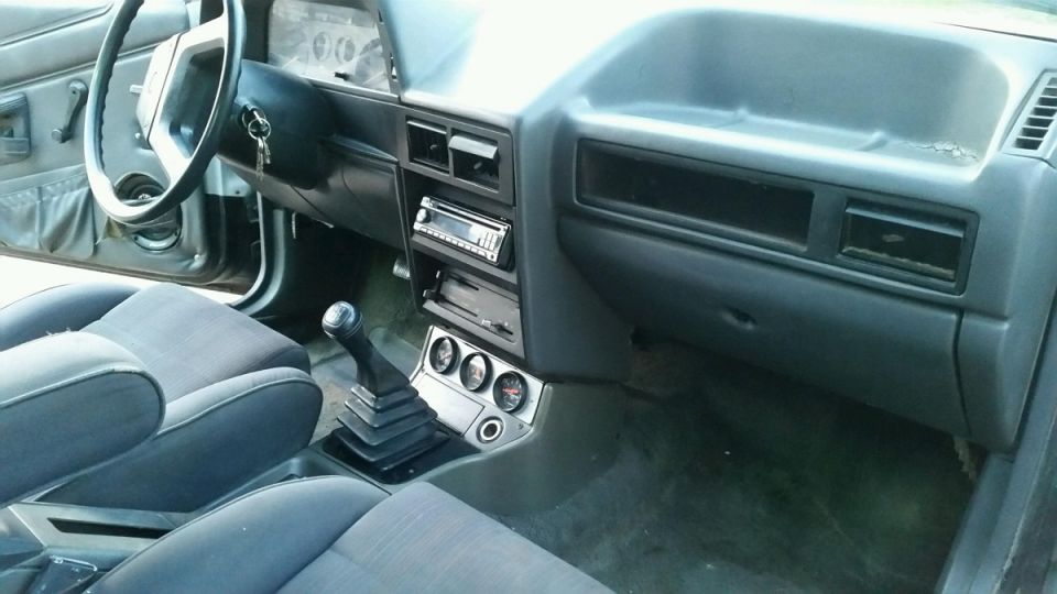 Pickup truck interior dash with manual shifter, aftermarket stereo and gauges