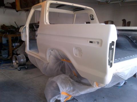 1979 Ford Bronco - The body of a 1979 Ford Bronco is shown in primer, undergoing preparation for a new paint job.