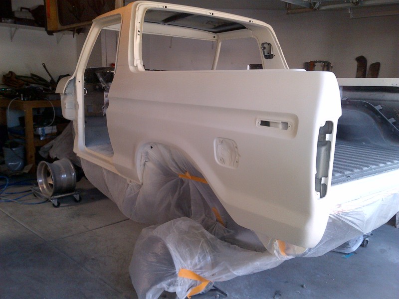 1979 Ford Bronco body, primed and prepped for paint, with rear quarter panel and tailgate visible