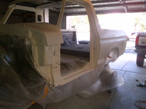 1979 Ford Bronco - A white 1978 Ford Bronco body is being prepped for paint, with another vehicle visible in the background.