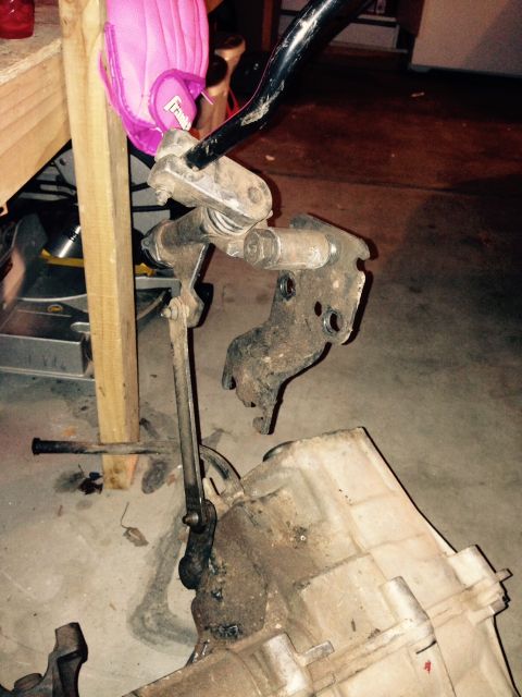 1995 Ford Bronco - A transfer case and linkage assembly is shown, with a pink object attached to a metal bar. The registry claims it is from a 1995 Ford Bronc…