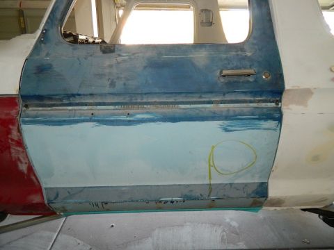1979 Ford Bronco - The door panel is undergoing repairs, with areas of primer and unfinished paint visible.