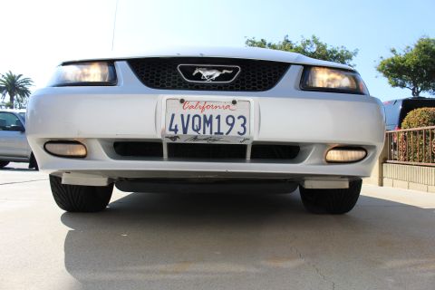 2002 Ford Mustang - Frontal view of a silver Ford Mustang, showing the grille, headlights, and license plate.
