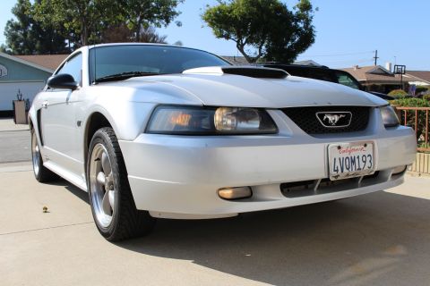 2002 Ford Mustang - Front quarter view of a silver 2002 Ford Mustang parked on a driveway.
