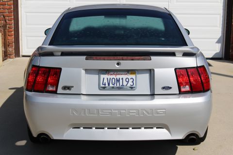 2002 Ford Mustang - Rear view of a silver 2002 Ford Mustang GT, GT badging and a California license plate.