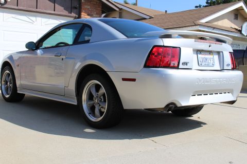 2002 Ford Mustang - Rear view of a silver 2002 Ford Mustang GT with a spoiler and GT badging.