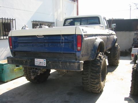 1985 Ford Bronco - This lifted pickup truck features a two-tone paint scheme and oversized off-road tires.