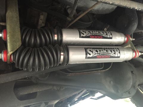 1995 Ford Bronco - Close-up of Skyjacker 9000 Suspension shocks, part of a vehicle's suspension system.