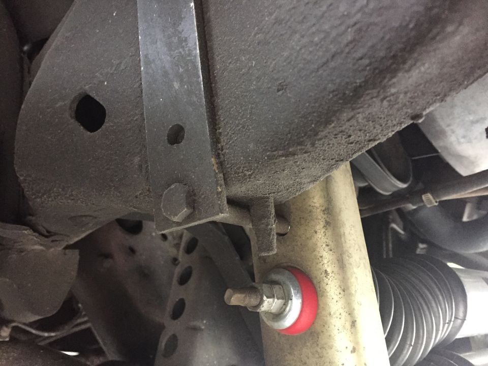 Close-up of red polyurethane suspension bushing and steering rack boot
