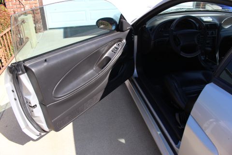 2002 Ford Mustang - The interior and driver side door of a 2002 Ford Mustang are visible.