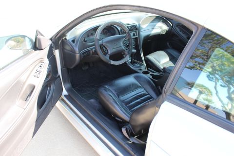 2002 Ford Mustang - Interior view of a car, showing the driver's seat, dashboard, and door panel.
