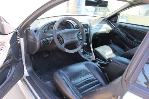 2002 Ford Mustang - Interior view of a 2002 Ford Mustang, highlighting the driver's side dashboard and seating area.