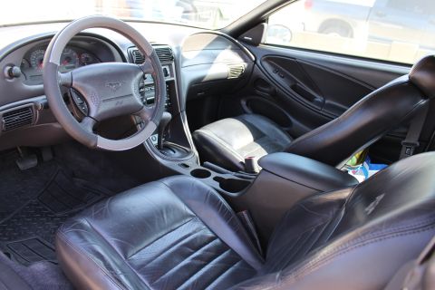 2002 Ford Mustang - Interior view of a 2002 Ford Mustang, highlighting the driver and passenger seats and dashboard.