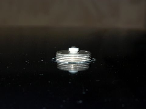 1990 Ford Bronco - Close-up of a metal component with layered discs and a central white piece.