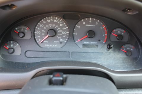 2002 Ford Mustang - Close-up of the instrument cluster in a 2002 Ford Mustang, displaying speed, RPM, fuel, and other vital information.