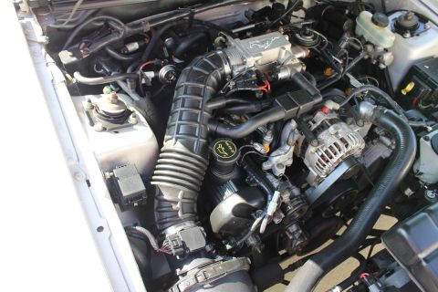 2002 Ford Mustang - The engine bay of a 2002 Ford Mustang, the V8 engine and prominent air intake system.