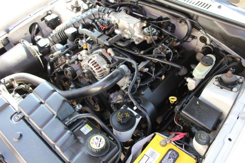 2002 Ford Mustang - Engine bay of a 2002 Ford Mustang, showing the V8 engine and associated components.