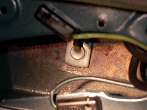 1990 Ford Bronco - Close-up of a rusty metal bracket with electrical connectors and wires.