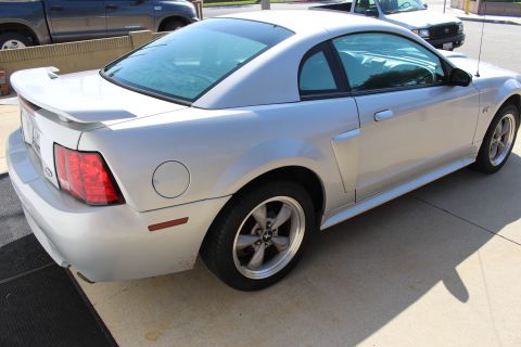 2002 Ford Mustang - Silver 2002 Ford Mustang coupe with a rear spoiler is parked outdoors.