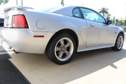 2002 Ford Mustang - Rear quarter view of a silver 2002 Ford Mustang coupe parked on pavement.