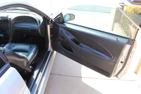 2002 Ford Mustang - Driver's side interior of a 2002 Ford Mustang, black leather seats and a view of the dashboard.