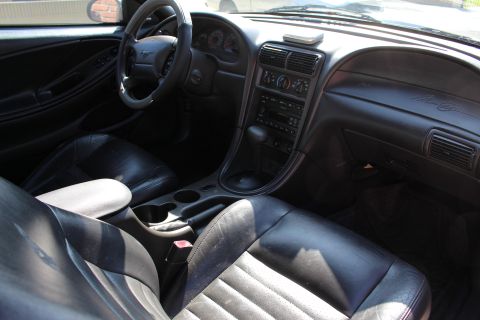 2002 Ford Mustang - Interior view of a 2002 Ford Mustang, highlighting the dashboard and seating.