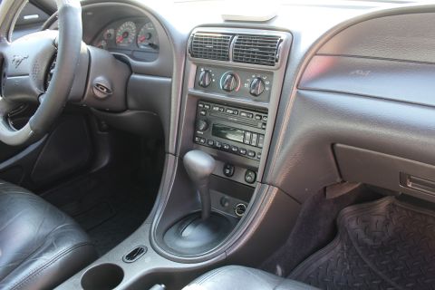 2002 Ford Mustang - Interior view of a 2002 Ford Mustang, showing the dashboard, steering wheel, and center console with automatic transmission shifter.