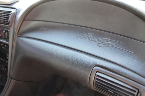 2002 Ford Mustang - Close-up of the dashboard emblem on a 2002 Ford Mustang.