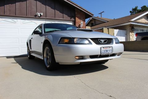 2002 Ford Mustang - Silver 2002 Ford Mustang parked in front of a garage with a California license plate.