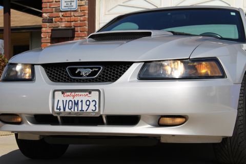 2002 Ford Mustang - Front view of a silver 2002 Ford Mustang with a black grille and California license plate.