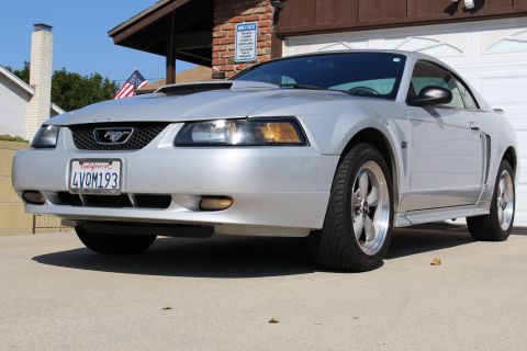 2002 Ford Mustang - Silver 2002 Ford Mustang parked in a driveway, showing its front 3/4 view and California license plate.