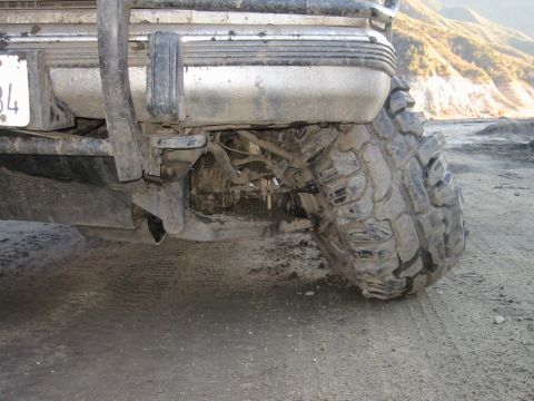 1985 Ford Bronco - This photo shows the rear tire and bumper assembly of a heavily modified off-road vehicle.