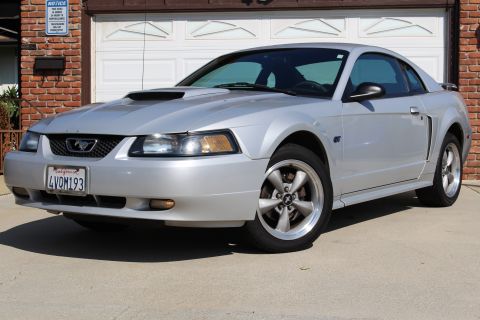 2002 Ford Mustang - Silver 2002 Ford Mustang coupe with a hood scoop and GT badging.