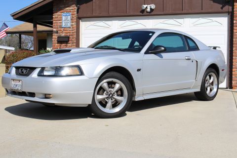 2002 Ford Mustang - This silver 2002 Ford Mustang coupe features GT badging and a hood scoop.
