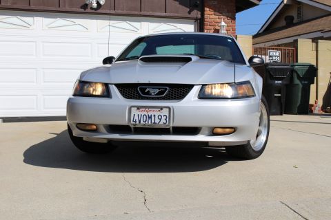 2002 Ford Mustang - Front view of a silver 2002 Ford Mustang with a hood scoop and California license plate.