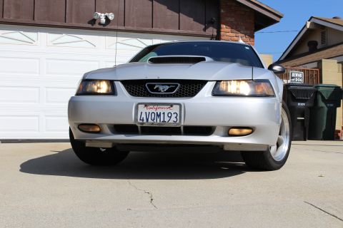 2002 Ford Mustang - Front view of a silver 2002 Ford Mustang parked in a driveway. The car has a California license plate.