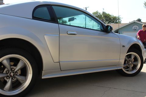 2002 Ford Mustang - Side profile of a silver 2002 Ford Mustang, parked outdoors.