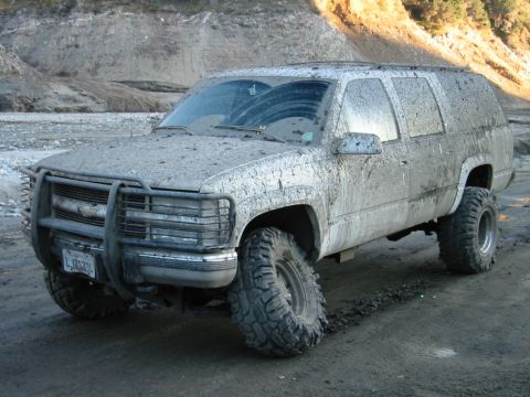 1985 Ford Bronco - This heavily muddied SUV, likely from the mid-1990s, is equipped for off-road adventures.