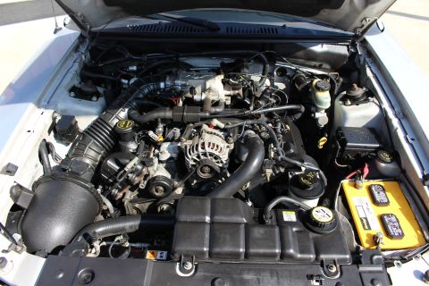 2002 Ford Mustang - Engine bay of a 2002 Ford Mustang, showing the V8 engine and related components.